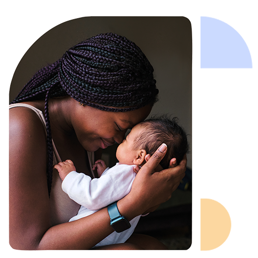 A parent holds their newborn baby tenderly.