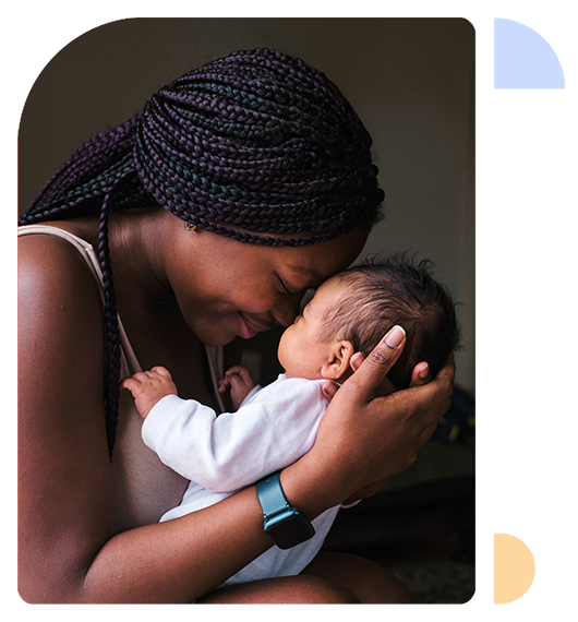 A parent holds their newborn baby tenderly.